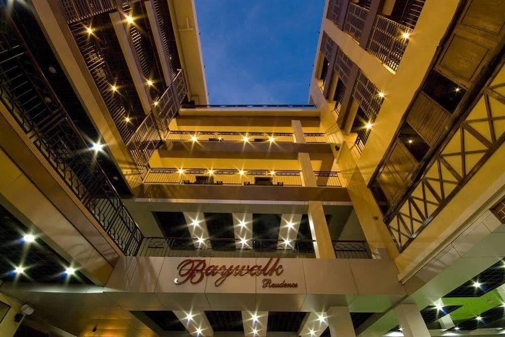 Baywalk Residence Pattaya's exterior illuminated at night, showcasing its modern architecture near the beachfront.